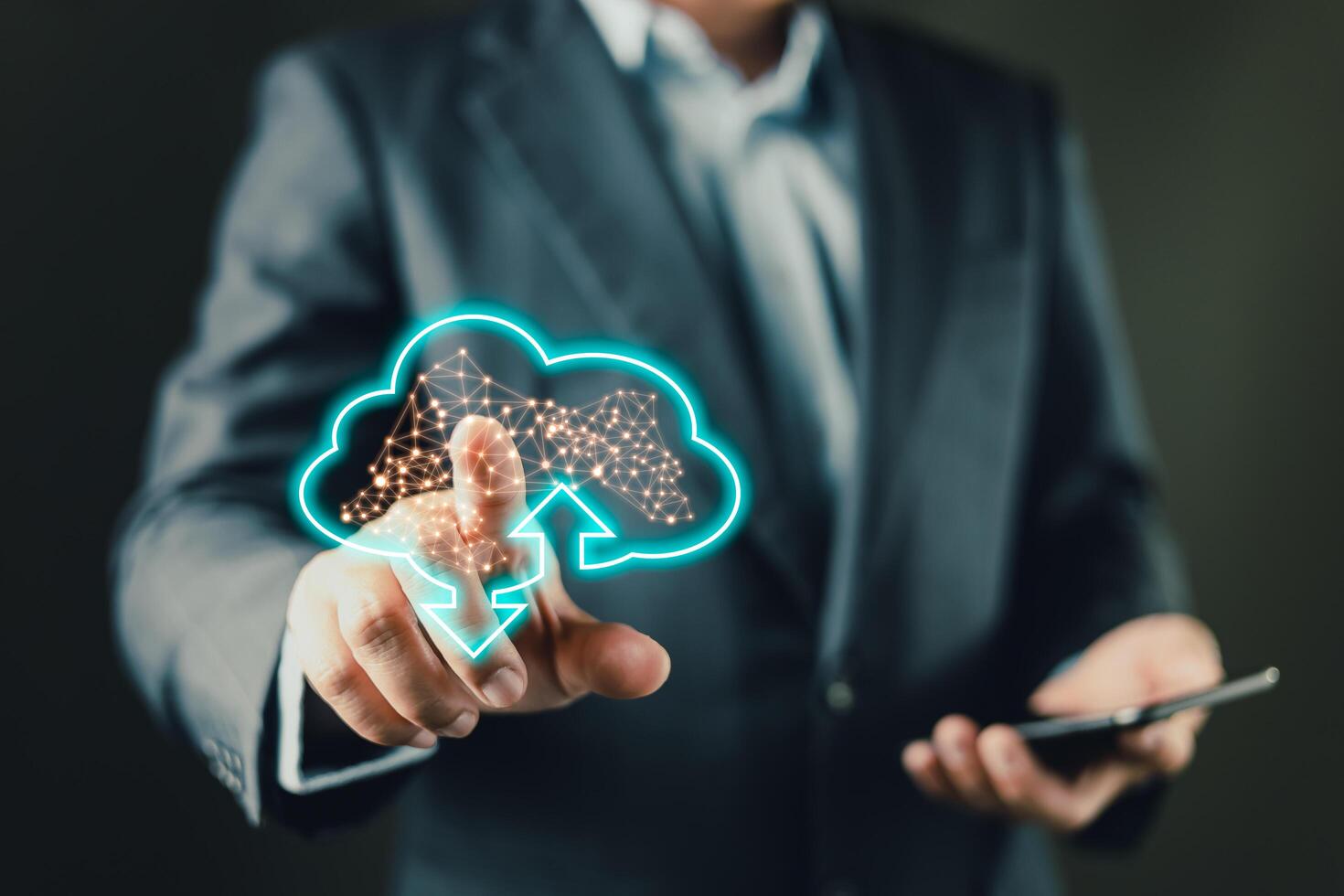 A businessman uses a tablet while interacting with a glowing cloud icon, symbolizing digital data upload and download processes, cloud computing, storage solutions, and modern network connectivity. photo