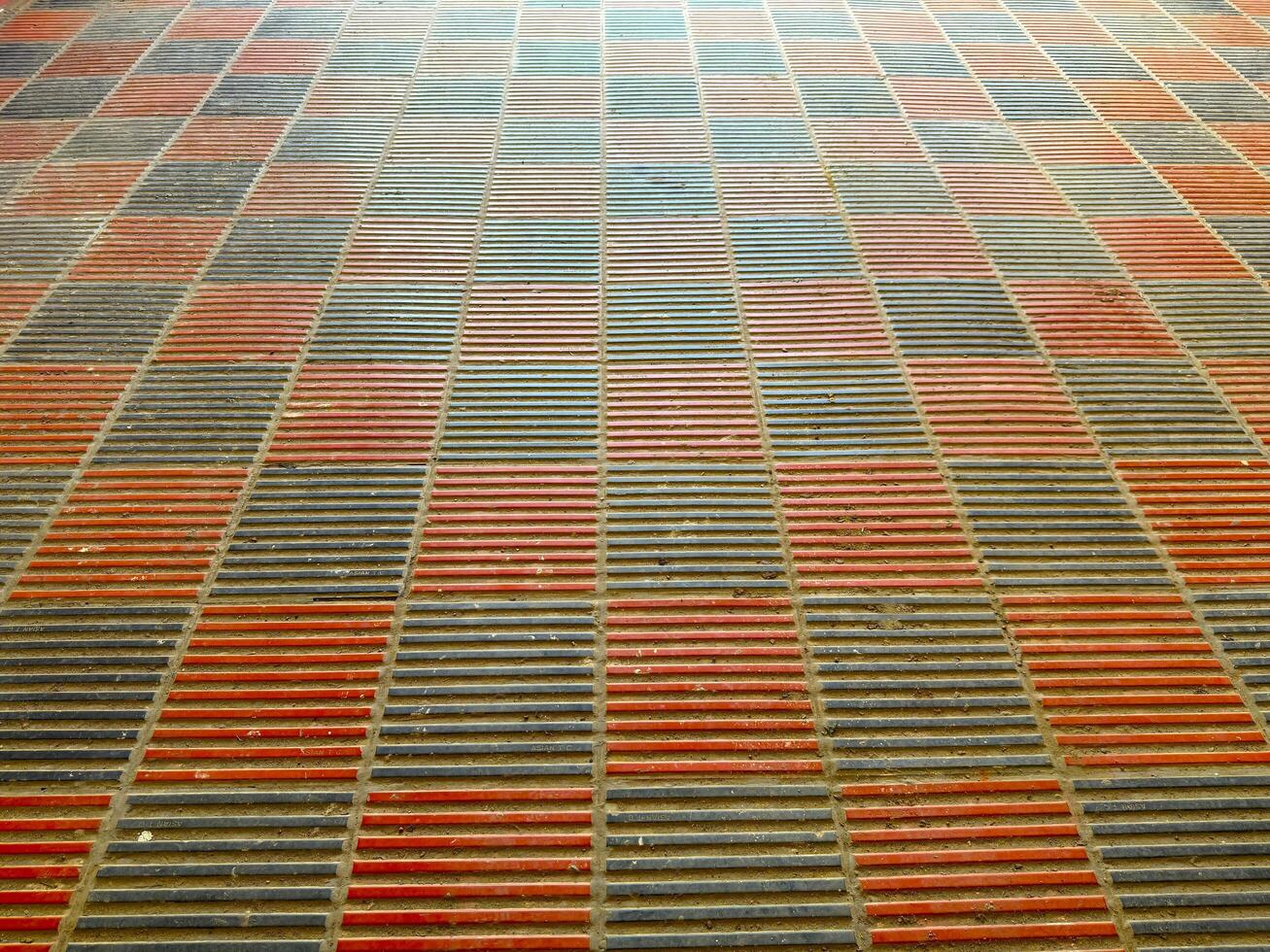 Abstract perspective shows a textured brick pattern with alternating rows in orange and gray photo