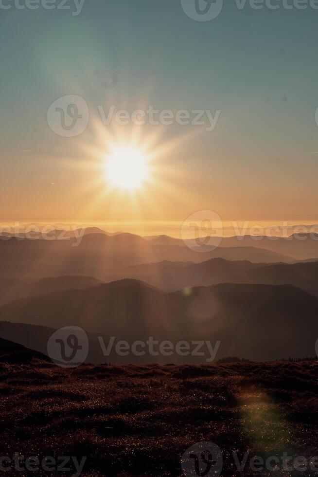 stunning golden hour view mountain ridges fading into the mist with warm sunlight casting soft shadows and a gentle gradient sky creating a serene peaceful scene captures beauty of untouched nature photo