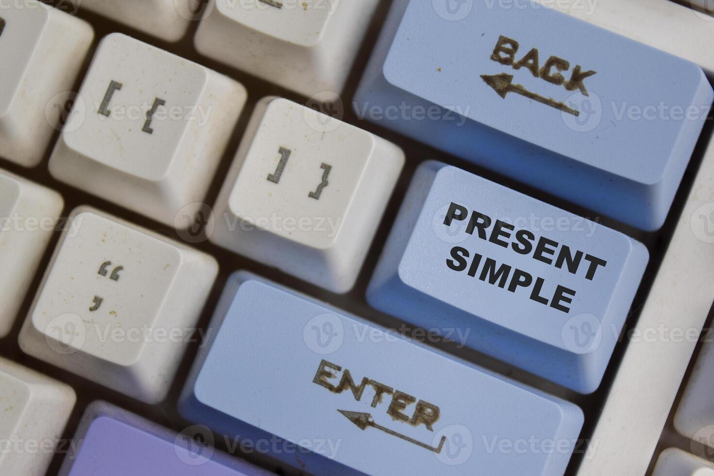 Present Simple one of the verb in modern english on the button keyboard photo