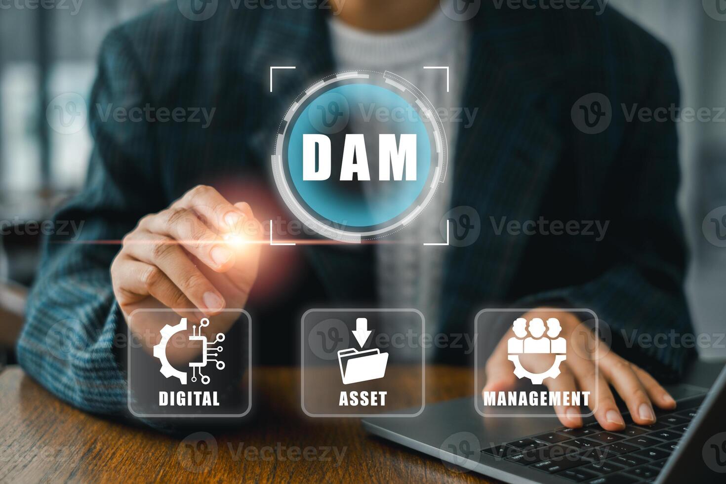 Visual representation of digital asset management with icons and a professional using a laptop for data organization. photo