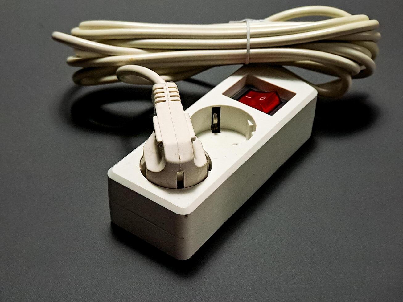 Power outlet with a coiled cord, showcasing a practical solution for electrical distribution, rendered in a minimalist style with a functional aesthetic, and clear organization. photo