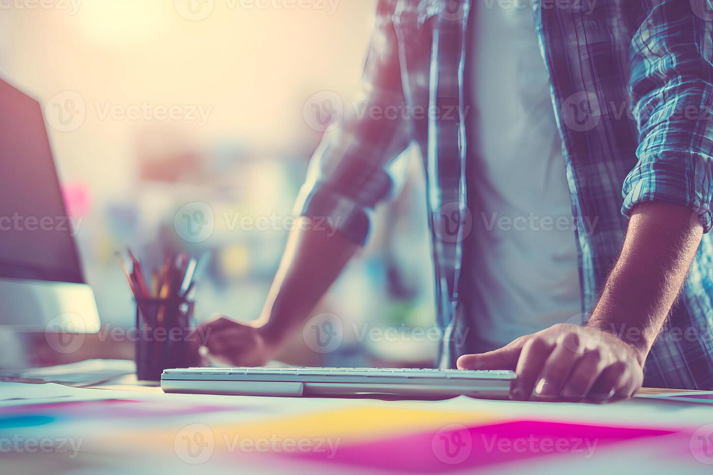 A person is working on a computer with a keyboard photo