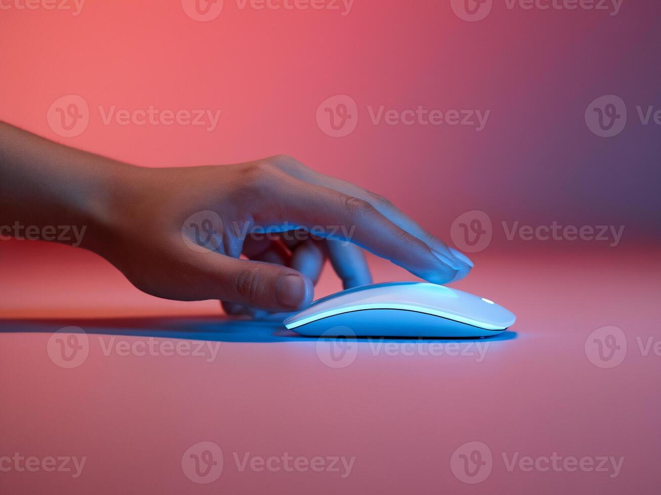 A hand using a sleek white computer mouse with a vibrant colorful background. photo