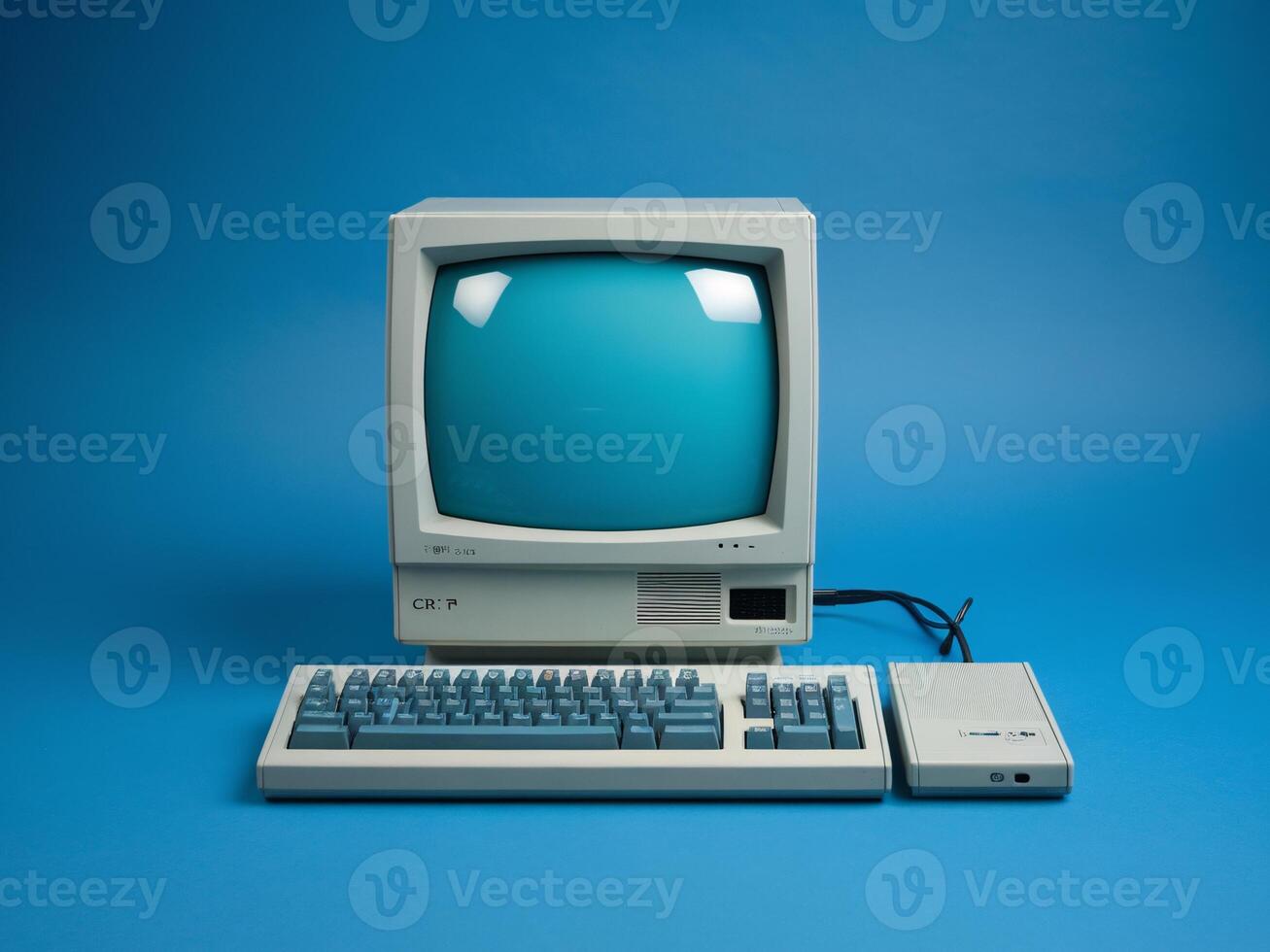 Retro computer setup featuring a CRT monitor and keyboard on a blue background. photo