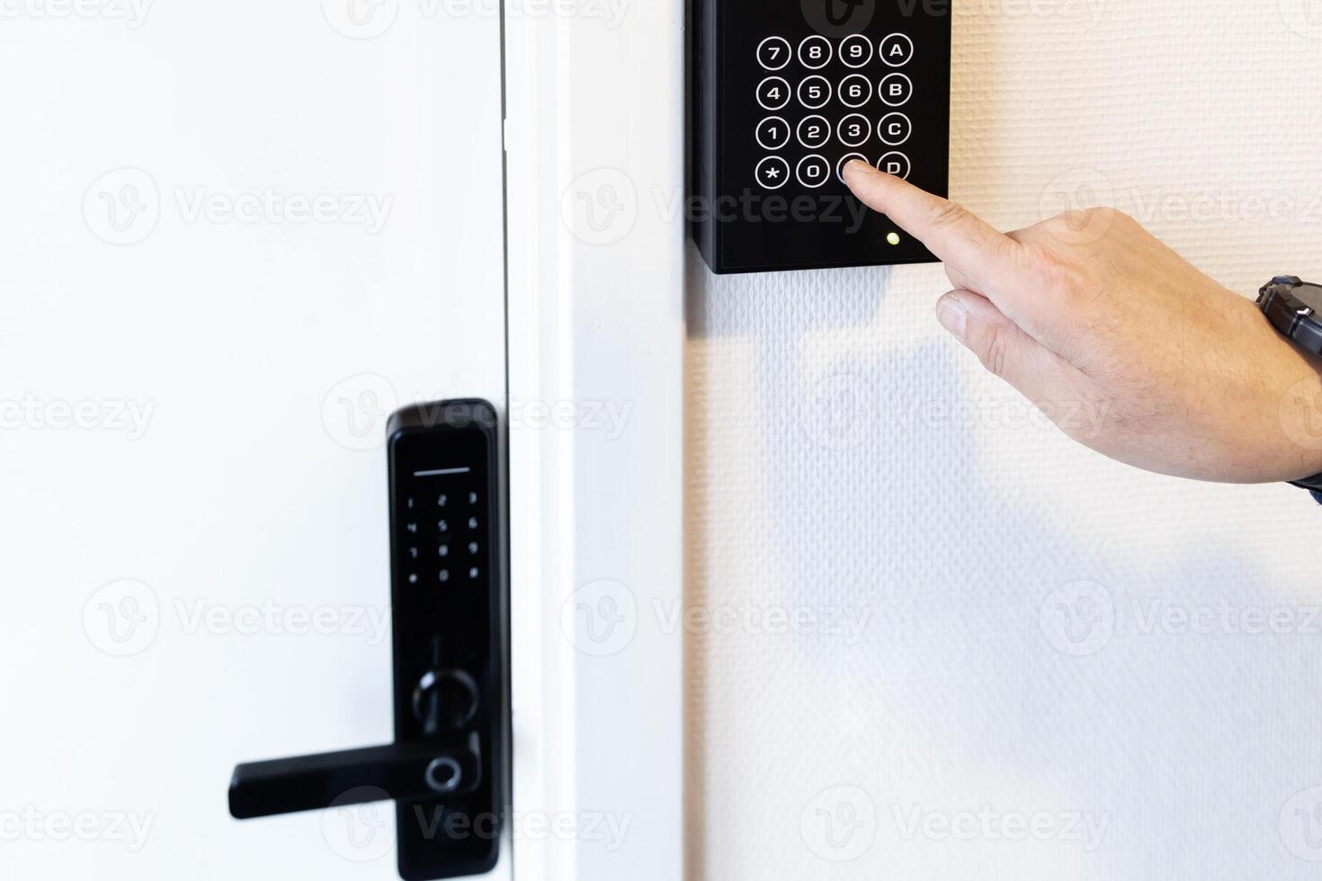 hand presses buttons with numbers to enter a code to open the door. photo