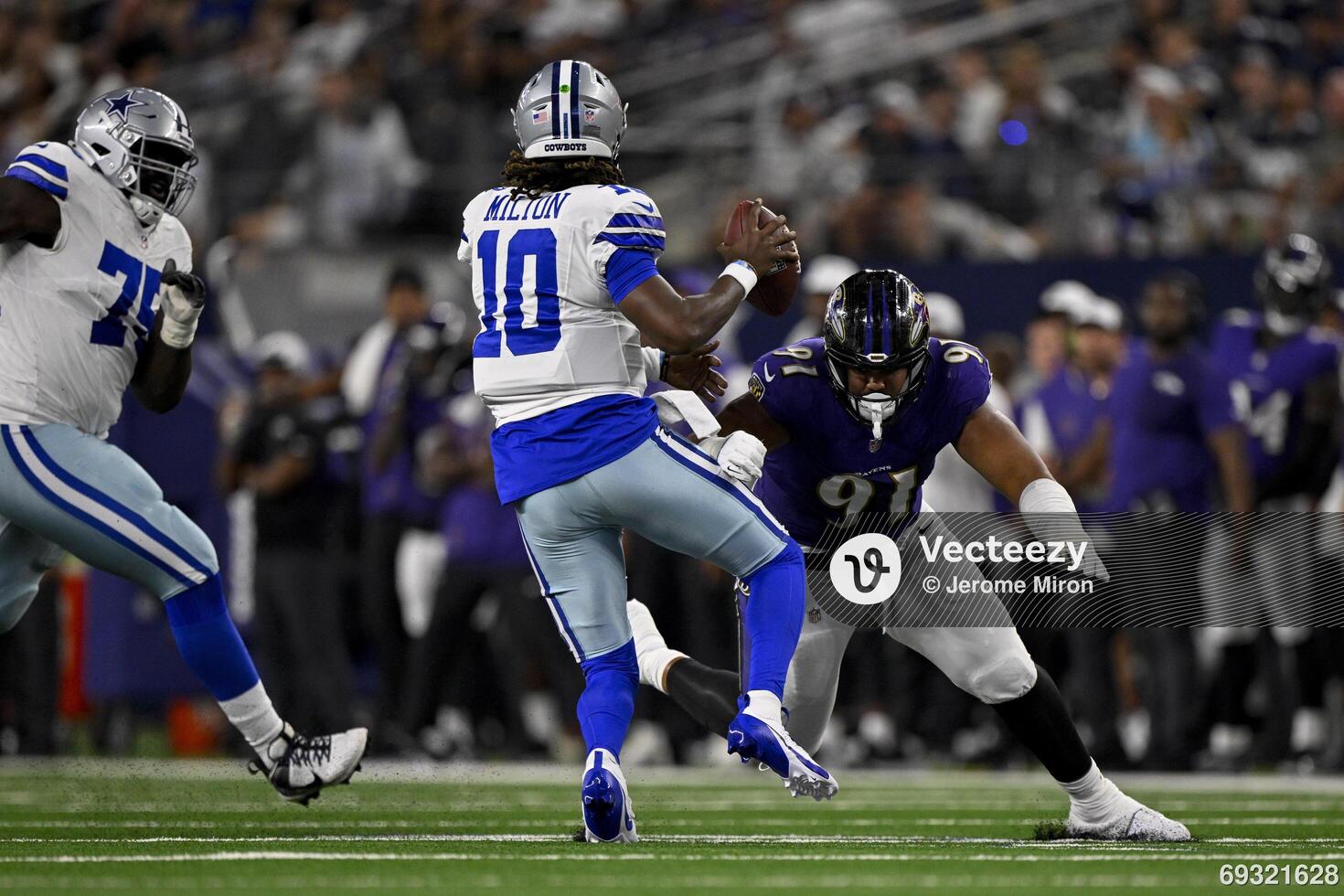 Dallas Cowboys quarterback Joe Milton III (10) eludes the tackle of Baltimore Ravens defensive end C.J. Ravenell (91) during the second quarter at AT&T Stadium. editorial_image