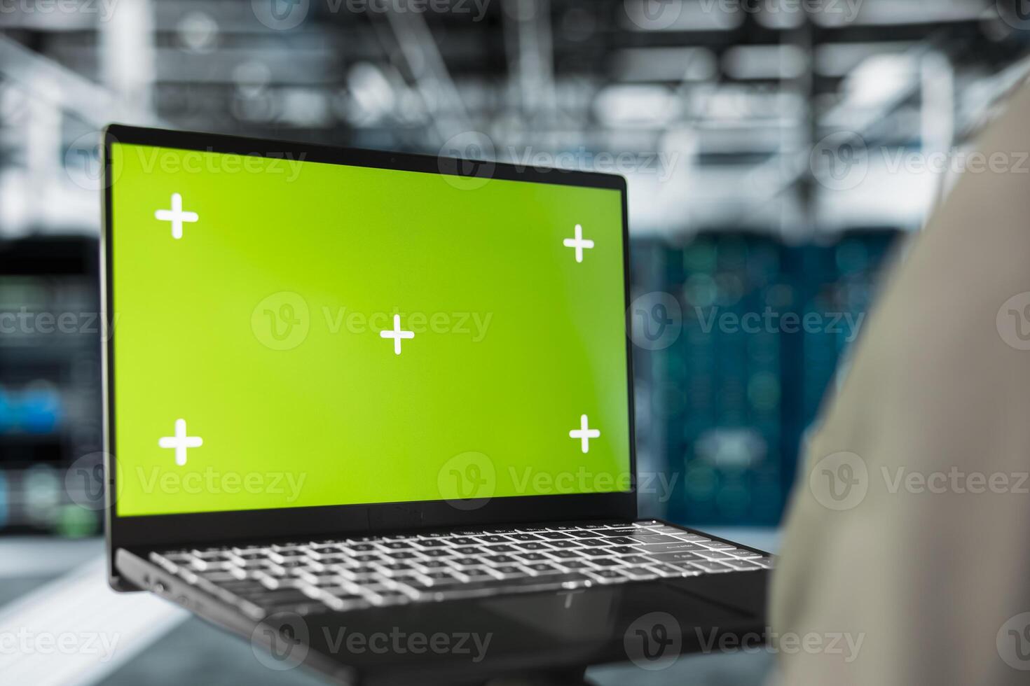 Close up of server hub engineer using mockup laptop to repair equipment storing datasets. IT professional using green screen notebook to do debugging on rigs doing computational operations photo