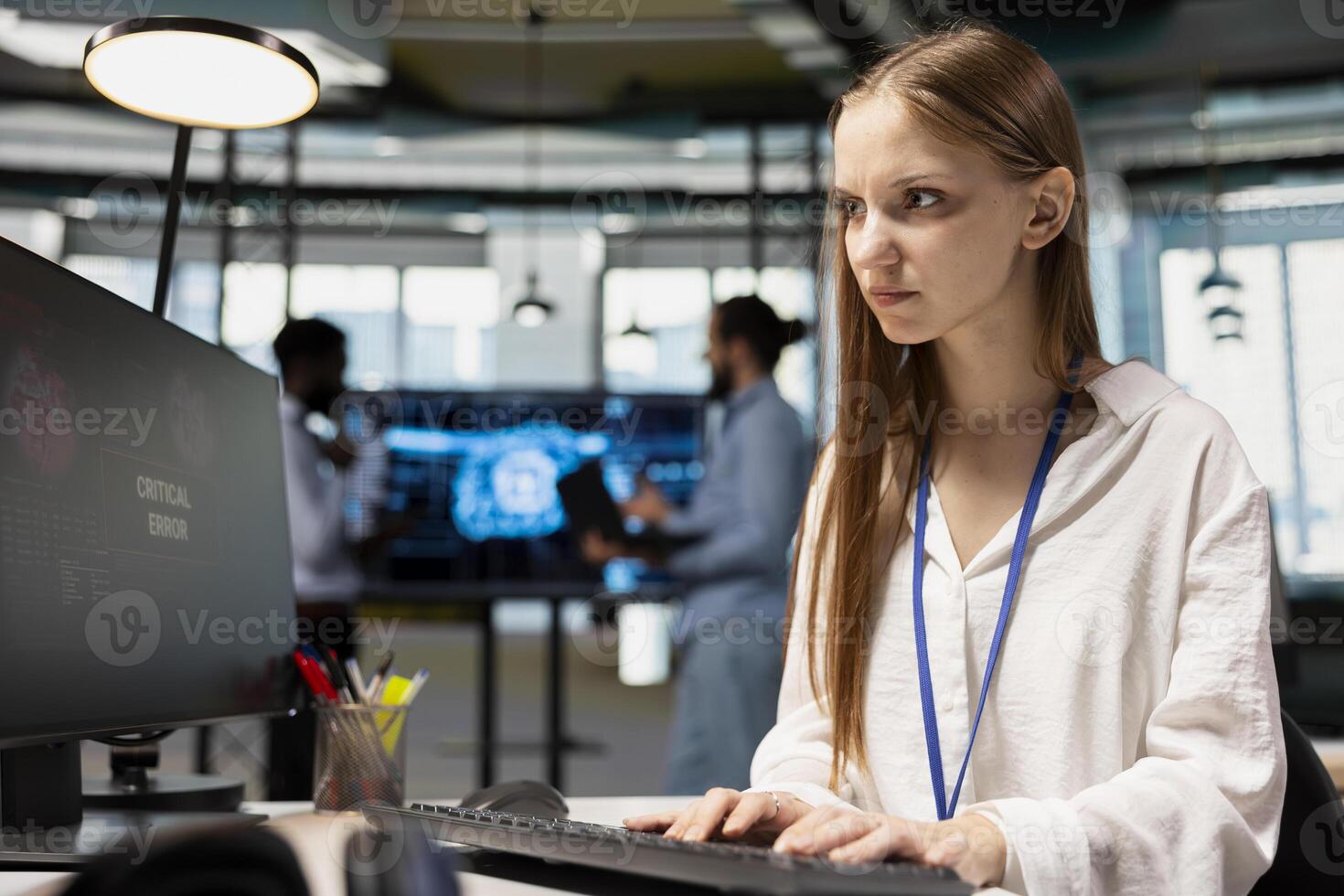 Anxious junior dev debugging code in office, looking for solutions to fix errors on PC display. Concerned system administrator reviewing error logs at computer, trying to to resolve critical glitches photo