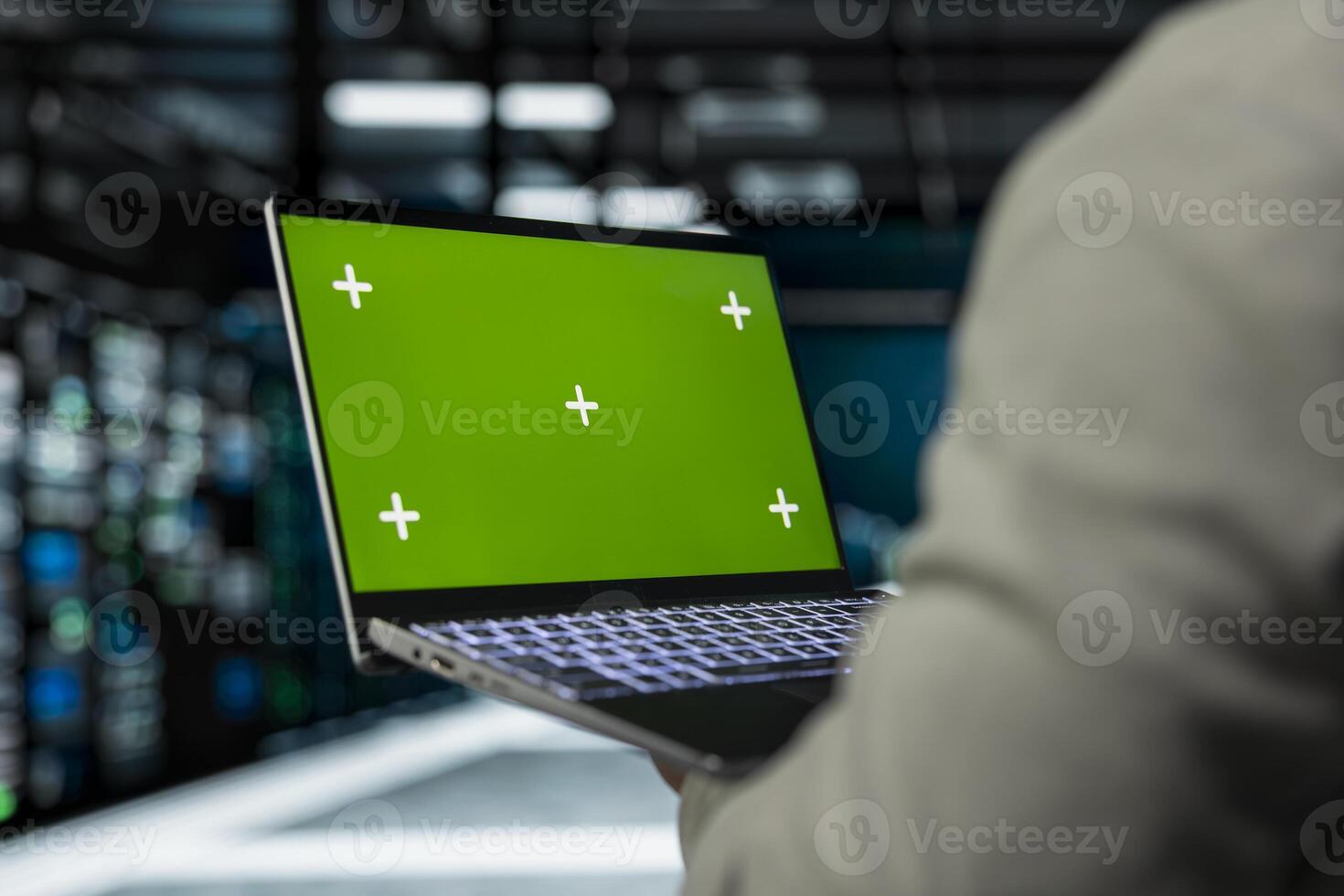 Close up of server farm software developer using mockup laptop to repair equipment storing datasets. IT specialist using green screen notebook to debug rackmounts doing computational operations photo