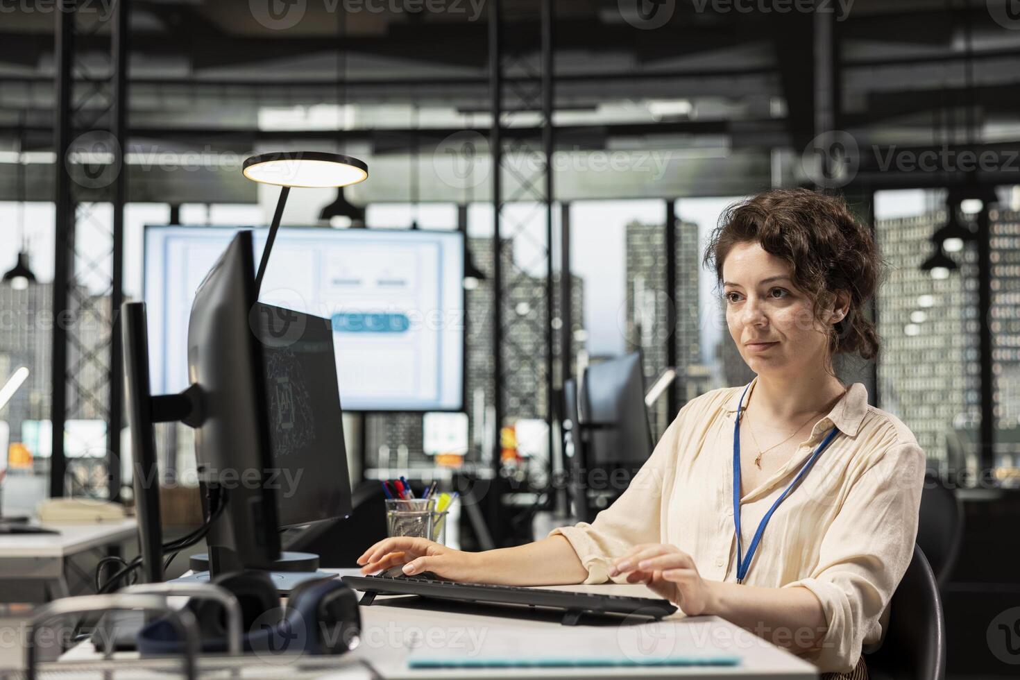 Female employee using AI machine learning for efficiency recognition, using a synergy of data sharing and optimization models in a co working space. IT company artificial intelligence. photo