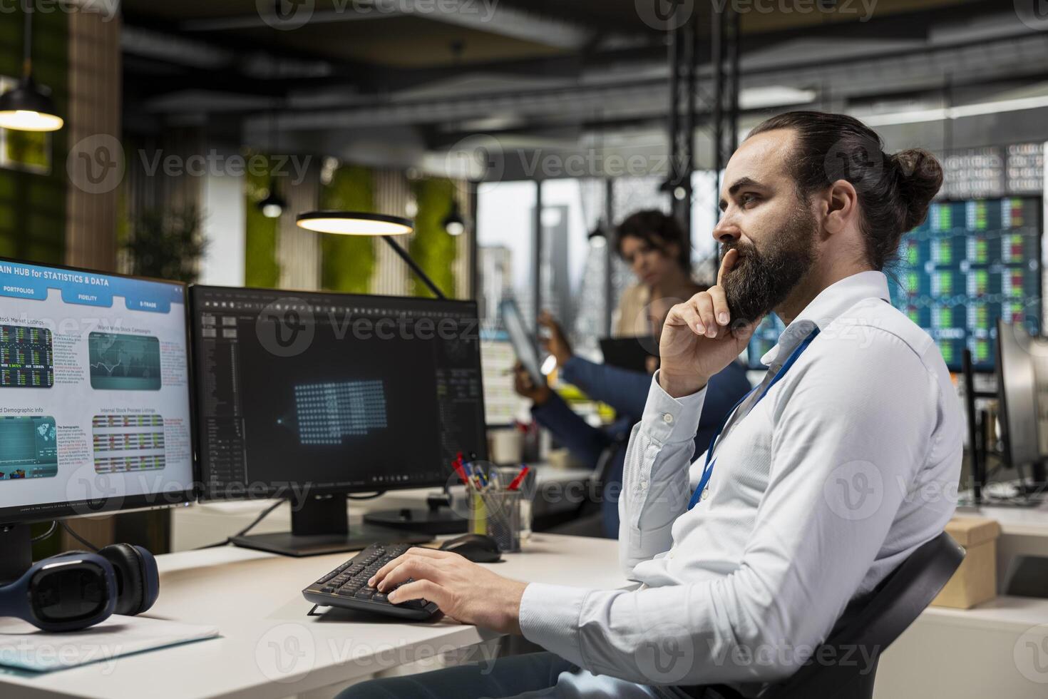 IT engineer reviewing data analysis results with artificial intelligence, integrating machine learning and automation tools to enhance productivity with dual monitors in the office. photo