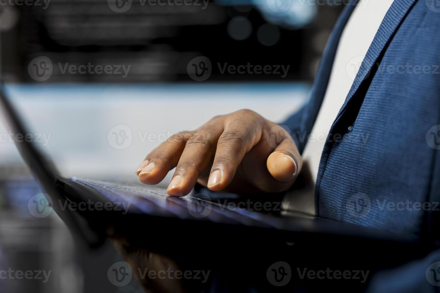 Black coder focused on programming with laptop at a digital workstation, writing binary code on terminal window for automation. Professional tech career in data science. Close up. photo