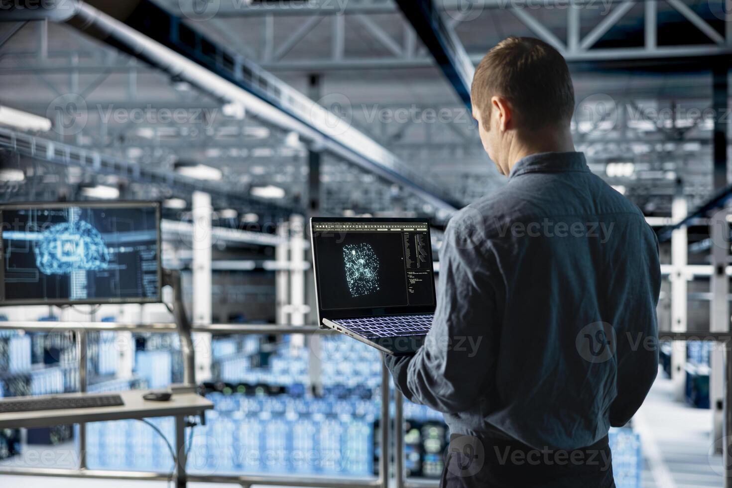 Data center IT specialist monitoring AI LLM visualization output to verify inference patterns. Programmer analyzing neural language network structure in server room using laptop photo