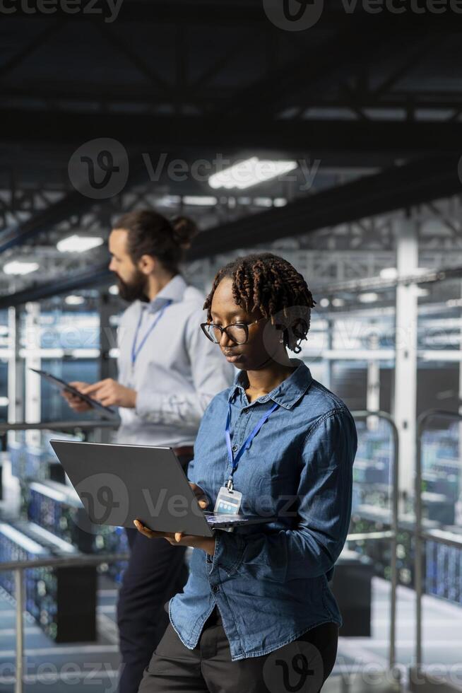 Data center programmer on industrial platform checking lines of code, collaborating on AI tasks. Server room IT specialist visualizing large language model architecture using computer. photo