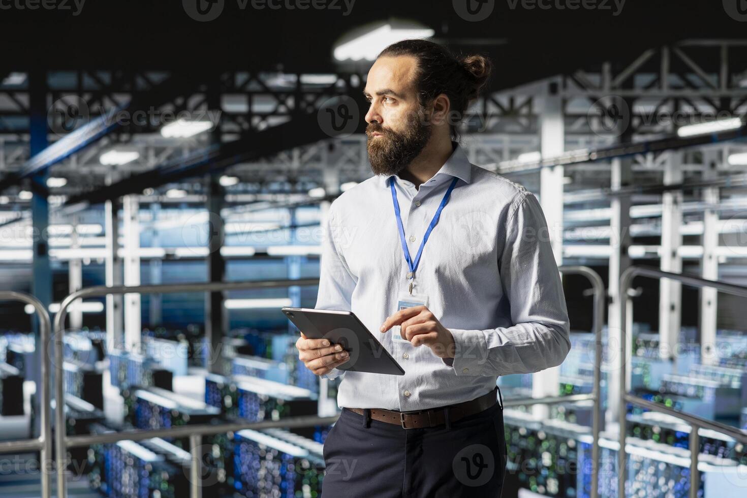 Server hub employee doing maintenance on server rigs with tablet, handling AI processing tasks. System administrator brainstorming and managing deep learning technology for development. photo