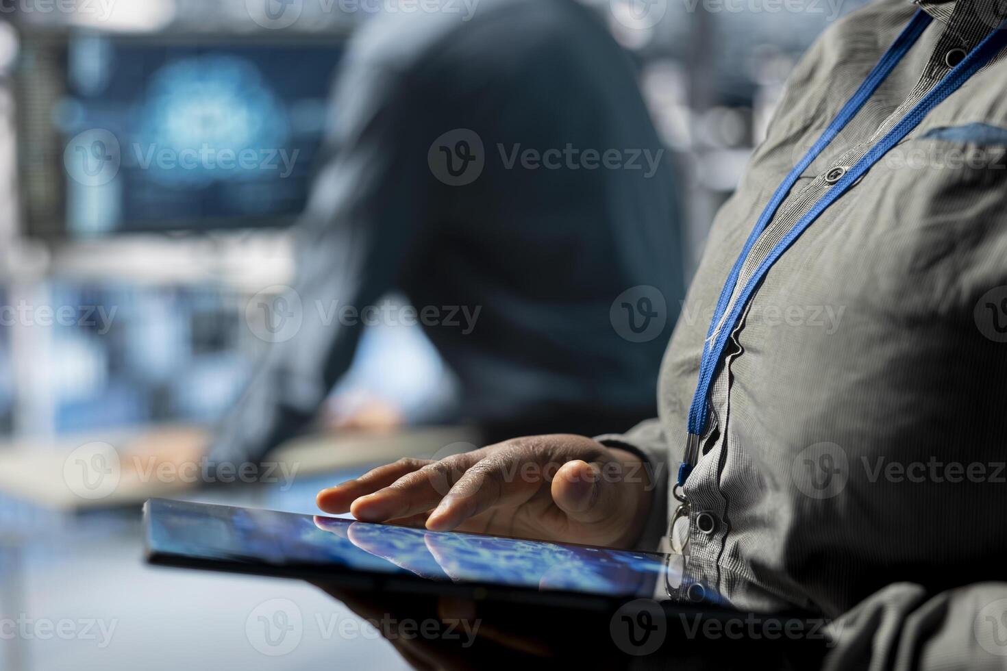 Close up of server farm IT expert using tablet to improve deep learning AI systems workloads. Data center software developer using device to adjust artificial intelligence model parameters photo