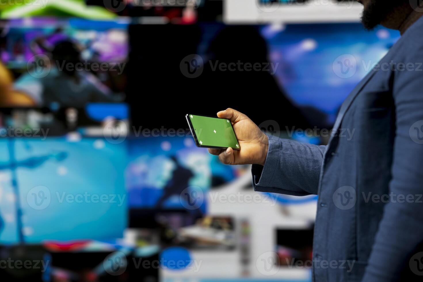 African american user holding a phone with isolated mockup display, digital system of networks and apps on dashboard. Highlighting the integration of AI and fintech. Multitasking. photo