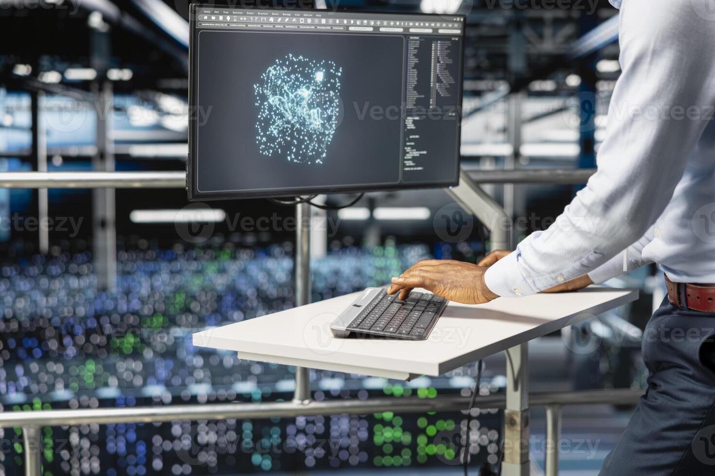 Black software engineer reviews machine learning systems on computer, standing on industrial platform at elevated workstation. Server hub technician monitoring AI infrastructure. photo