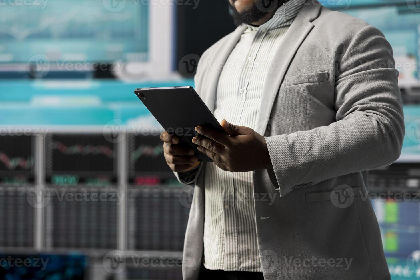 Black entrepreneur thinking about a new projection to increase revenue, evaluating infographics and financial reports with digital tech tools and analytics. Success and development. photo