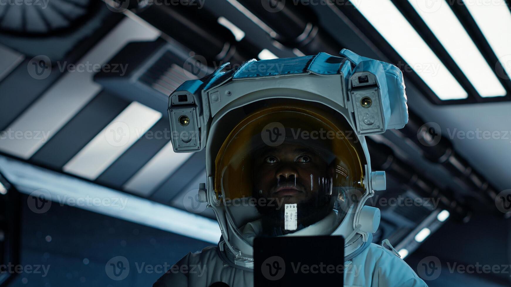 Astronaut researcher wearing equipment using tablet to carry out research. Scientist wearing cosmonaut gear in spaceship monitoring life support systems during flight using device, camera B photo