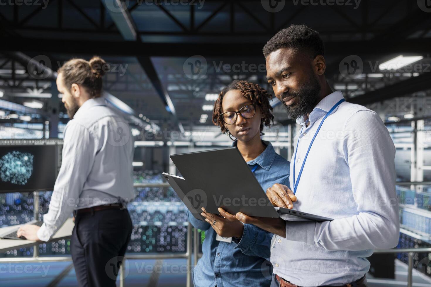 Black engineering team doing maintenance on server rigs for AI processing tasks. Server hub coworkers managing storage arrays supporting machine learning training workflows, high tech. photo