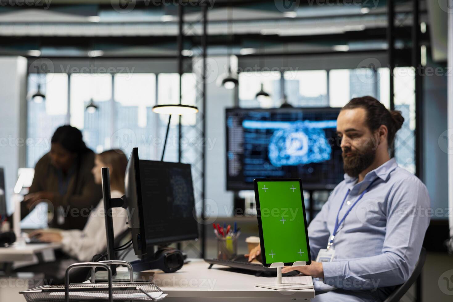 Startup office engineer using green screen tablet, developing artificial intelligence models for business analytics. IT specialist using mockup device, running simulations for AI forecasting photo