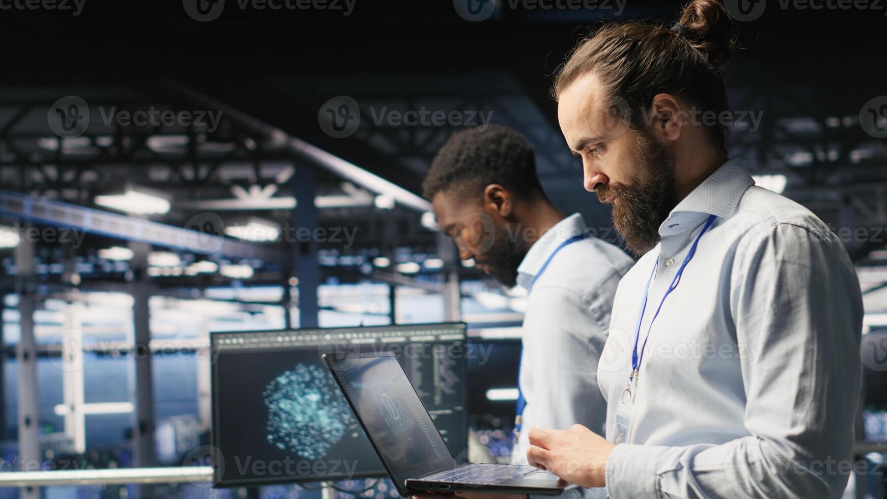Technician holding laptop walking on server farm platform, doing AI machine learning automatization. Data center programmer using notebook, doing maintenance using artificial intelligence photo