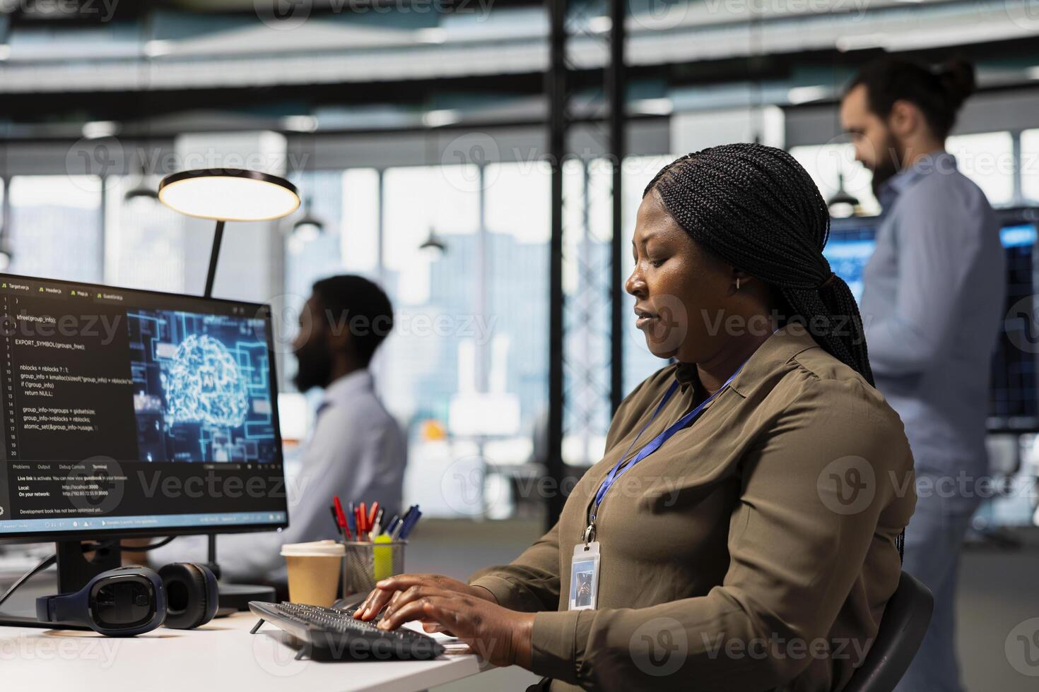 Software engineer using AI automation in tech workspace, building digital solutions. African american IT specialist working on PC to identify and fix bugs using artificial intelligence tools photo