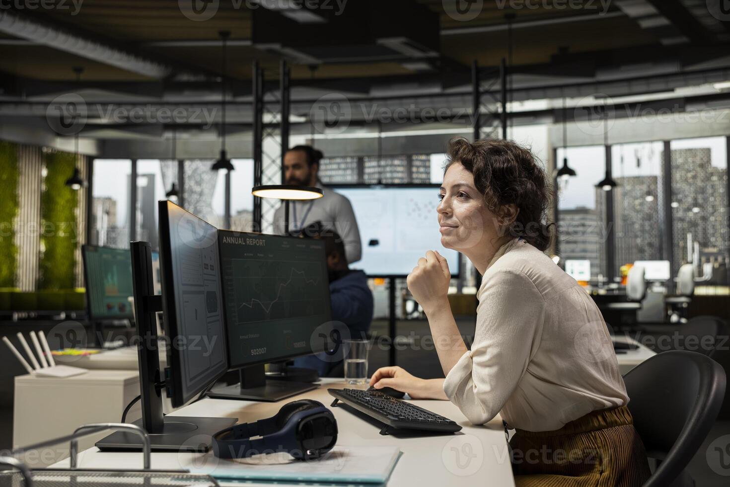 Motivated employee analyzing performance metrics and reports, applying business strategy and insights to enhance management practices and ensure corporate success. Modern workspace. photo