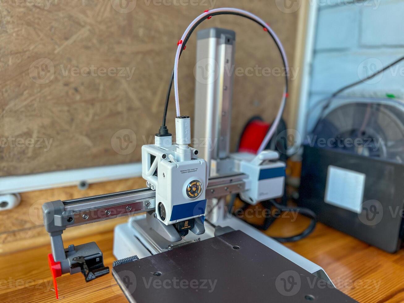 Modern 3d printer creating objects with additive manufacturing technology photo