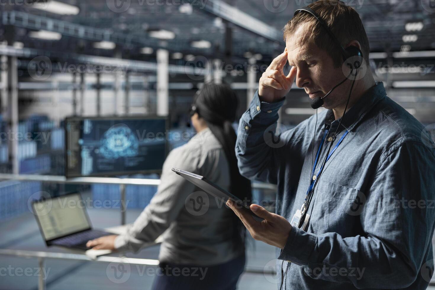 Server hub technicians identifying hardware issues using predictive machine learning alerts, guiding users. Teamworking data center coworkers using headset mic, using AI to resolve clients issues photo