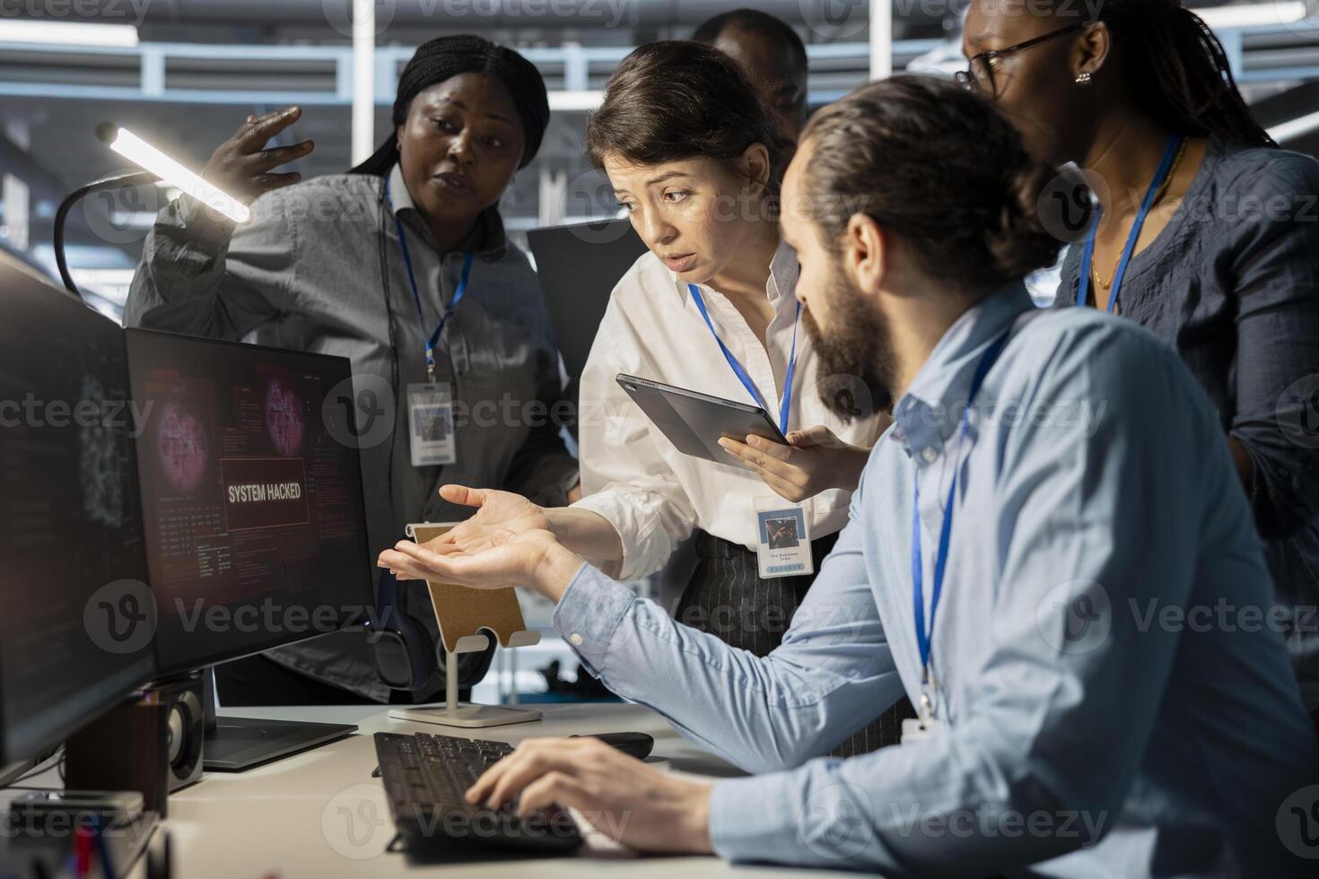 Data center technicians reacting to virus alert on computer monitor, initiating protocol to protect critical systems. Server room teamworking colleagues assessing compromised gear after hacker attack photo