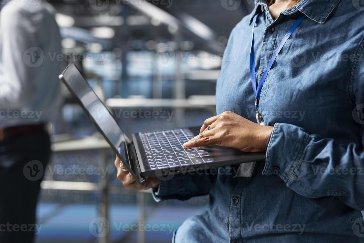 Server farm engineer managing storage arrays supporting machine learning for system management workflow. Technician on industrial platform handling AI processing tasks, programming. photo