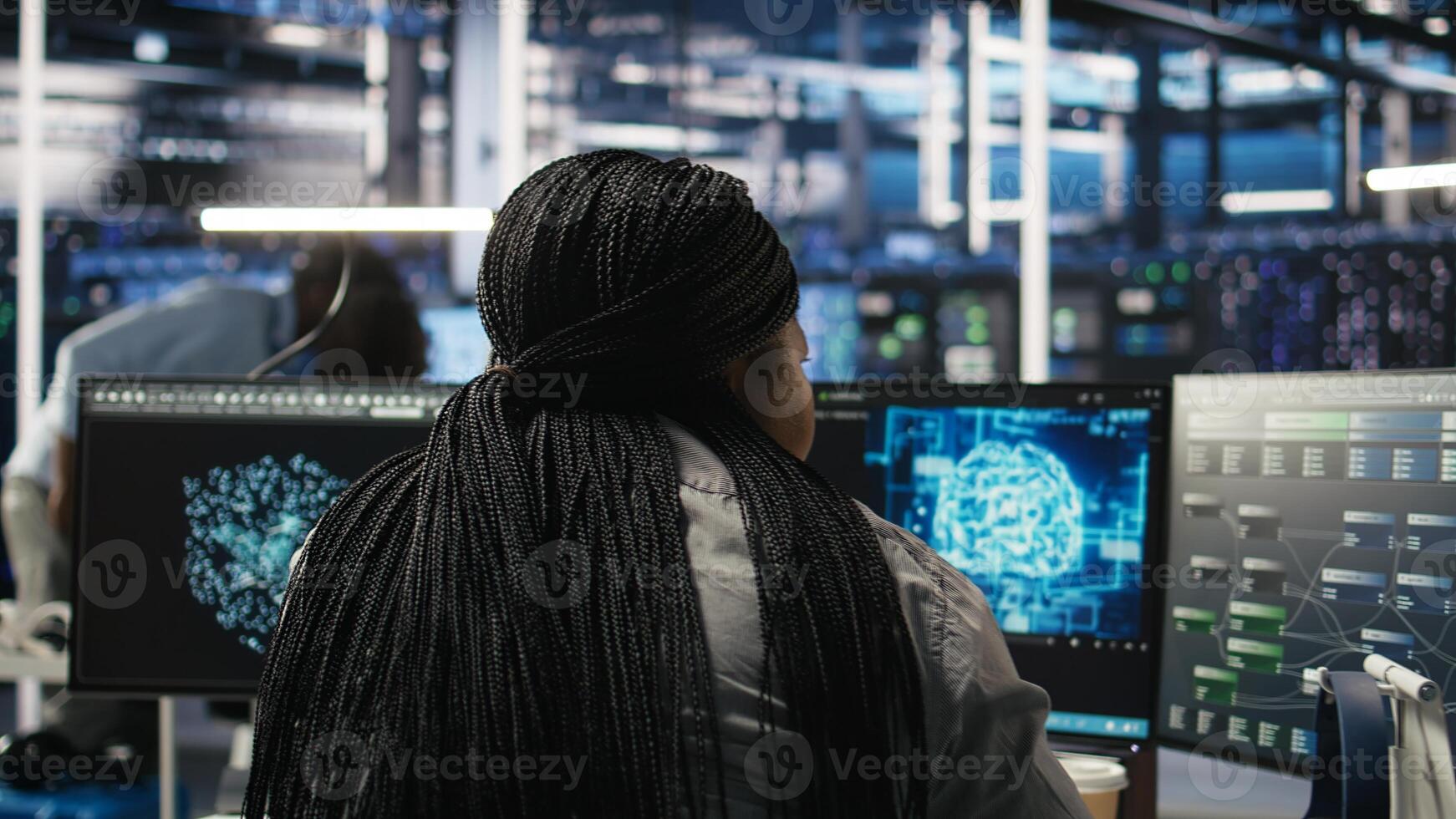 Data center staff member in office using AI deep learning algorithms to analyze datasets. African american woman in server room using artificial intelligence neural networks, camera A photo