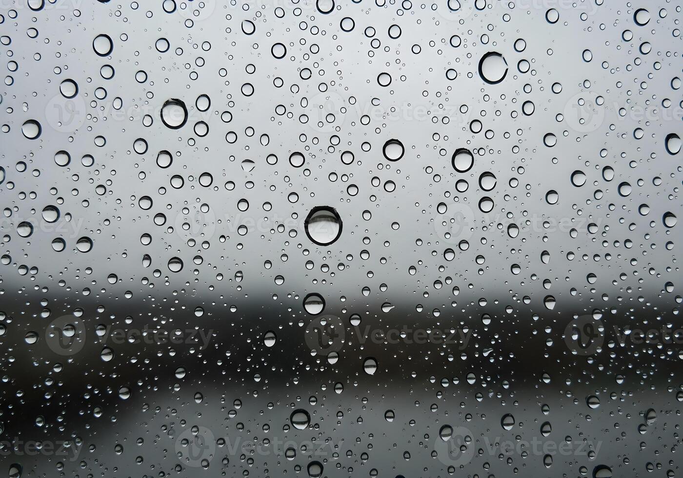 Macro rain droplets on glass window with blurred nature background, clean and sharp abstract texture image with natural lighting and no human elements photo