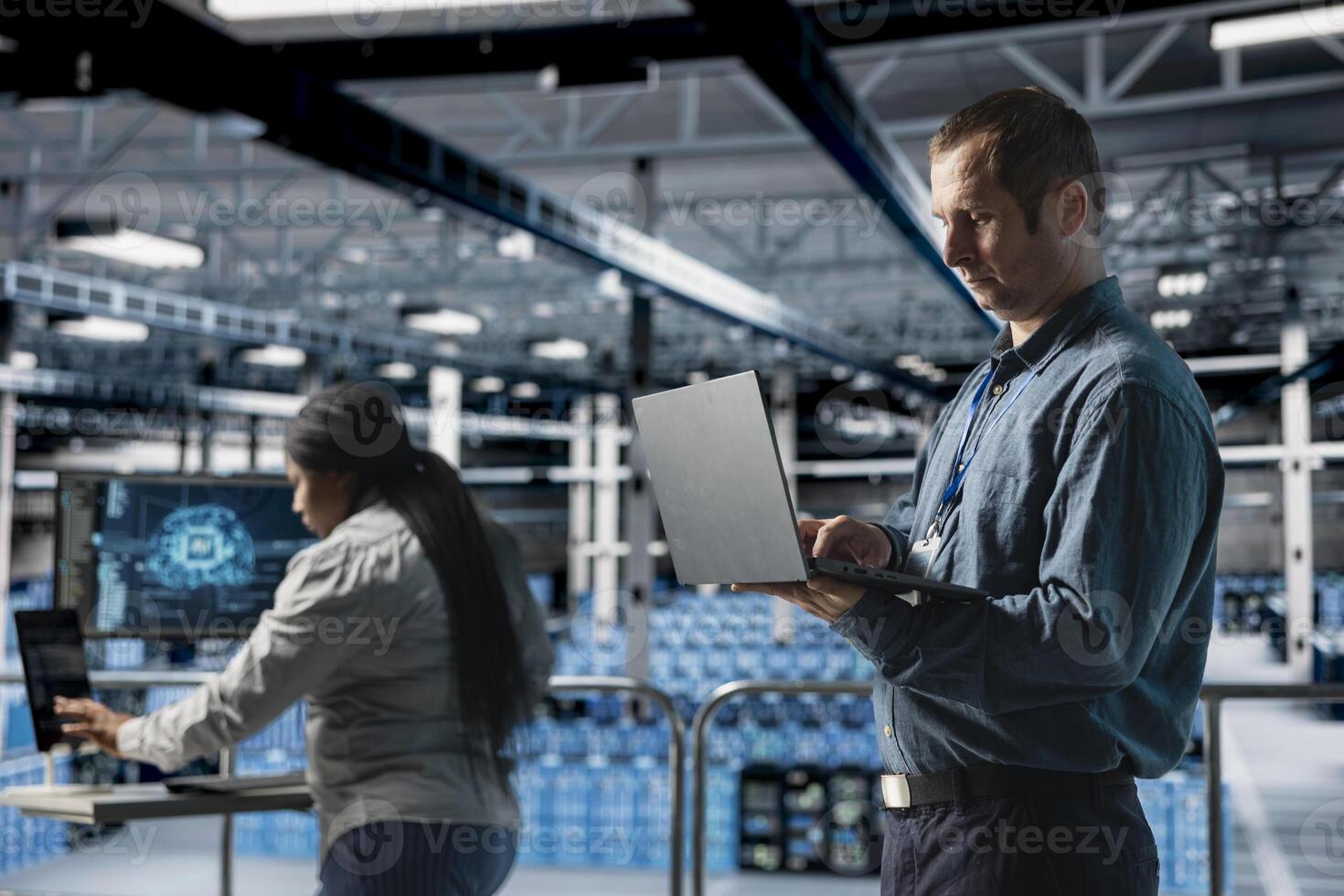 Server farm team of technicians debugging machine learning scripts on laptop, doing AI automatization. Data center programmer and coworker optimizing neural networks, adjusting deep learning models photo