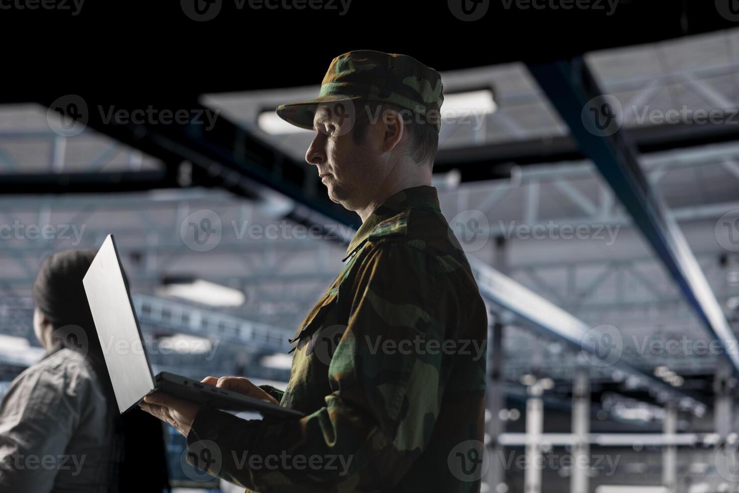Army information technology expert in data center configuring encrypted servers to protect sensitive defense data. Soldier in command center server room managing military IT infrastructure photo