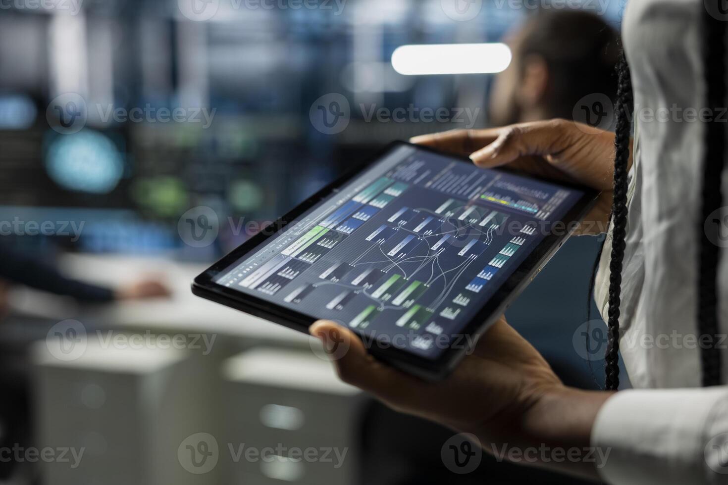 Close up of data center developer running simulations on tablet for AI forecasting, tracking performance. Server hub IT expert using device, integrating artificial intelligence APIs into software photo