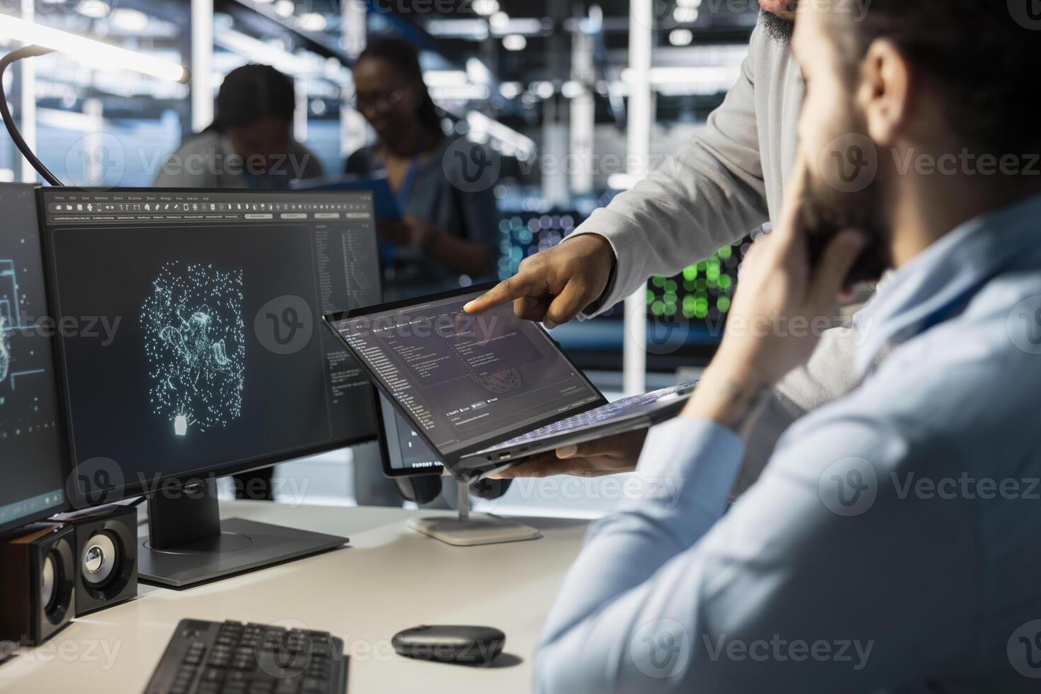Close up of data center admins monitoring system performance using laptop, identifying bottlenecks. Server farm IT experts using notebook to troubleshoot glitches, implementing optimizations photo