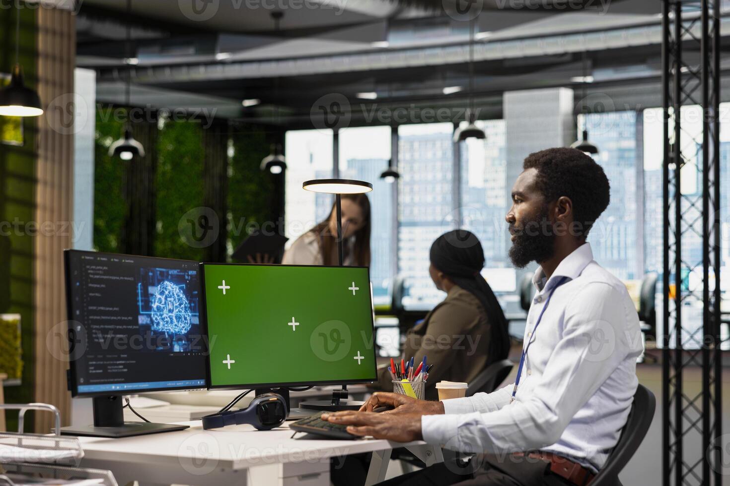 Technician using green screen PC to code, testing AI applications to minimize bugs, improving system stability. IT specialist in tech startup office optimizing performance using chroma key computer photo