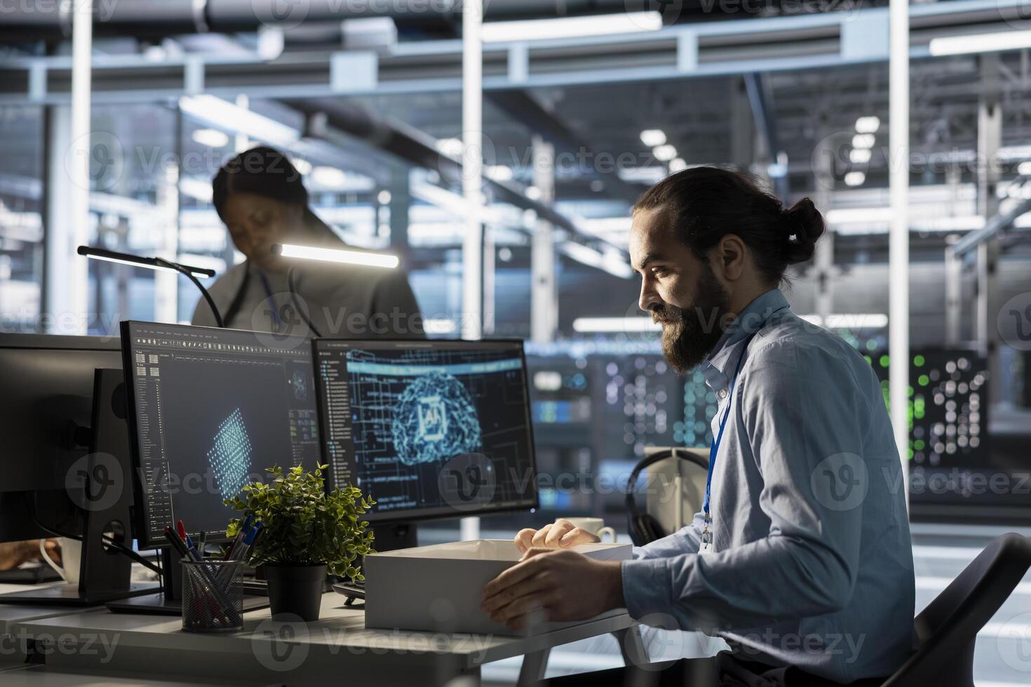 Admin in data center packing desk belongings after being replaced by AI automation handling infrastructure operations. Employee suffering from workforce displacement by artificial intelligence photo