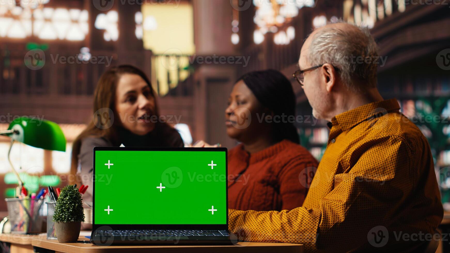 Colleagues practicing script reading in a public library with mockup, engaged in drama rehearsal and character development. Cast members preparing for classic theatre performance. photo