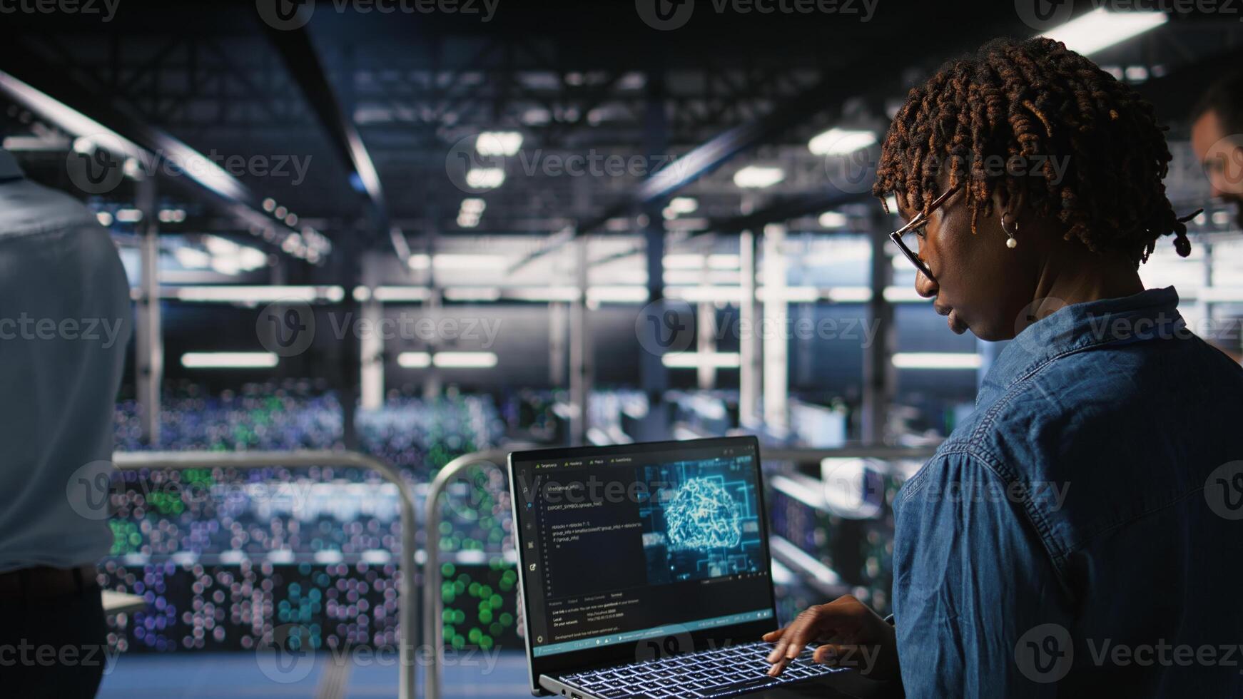 System administrators in data center monitoring AI LLM visualization. African american server farm coworkers overseeing rigs powering machine learning processes, photo