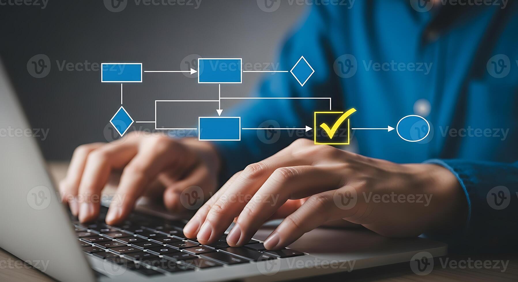Person working on a laptop with a digital flowchart and workflow visualization appearing above the keyboard indicating process and data flow management photo