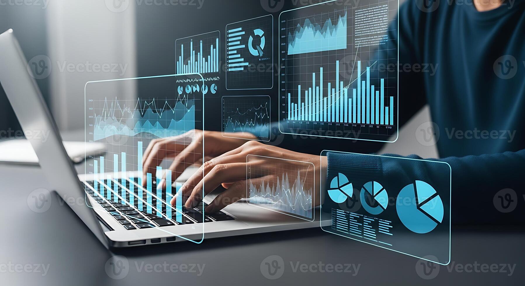 Person typing on a laptop with futuristic data visualization overlays displaying graphs and charts photo