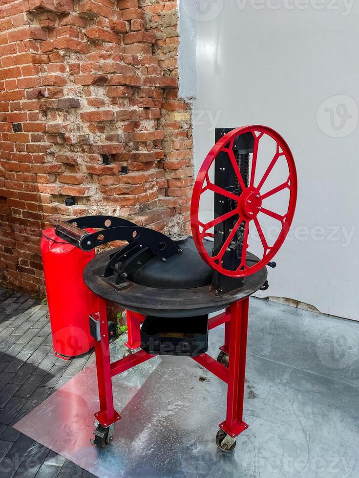 This Vintage Industrial Machine features a striking Red Wheel and stable Base on wheels, perfect for enhancing creativity and functionality in various art and design projects photo