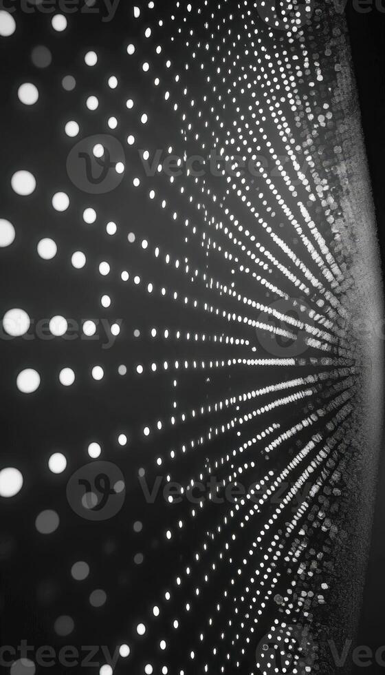 Abstract pattern of circular lights forming a dynamic radial design in monochrome photo