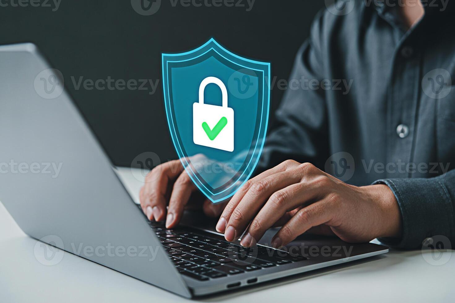 Cyber security concept man using laptop with shield and lock icon for data protection 100 character photo