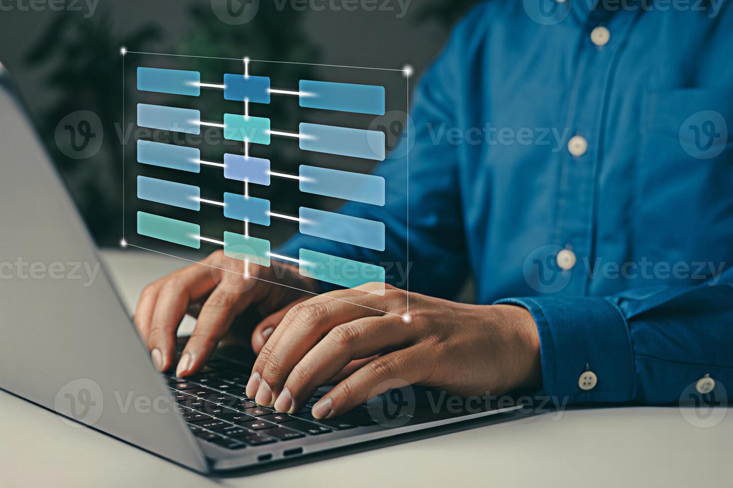 Man working on laptop with flowchart diagram for data analysis and project management planning task photo